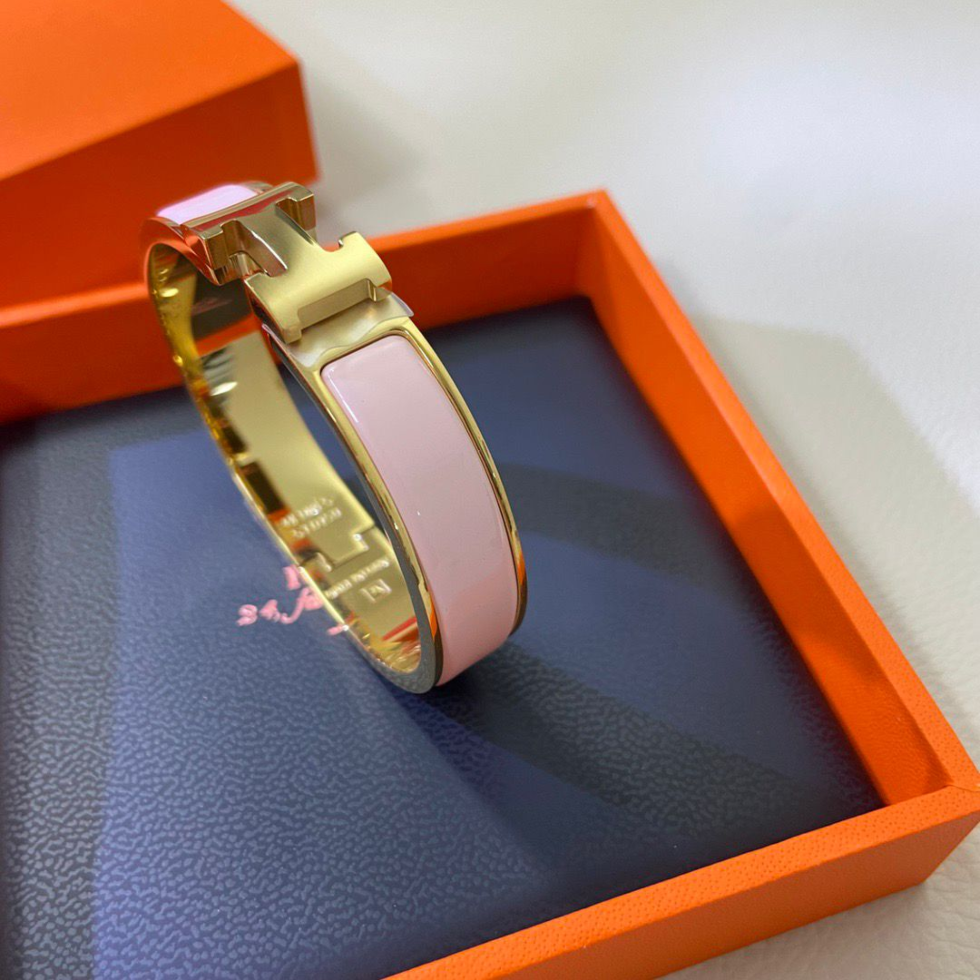Hermes Clic H Bracelet in Gold and Pink