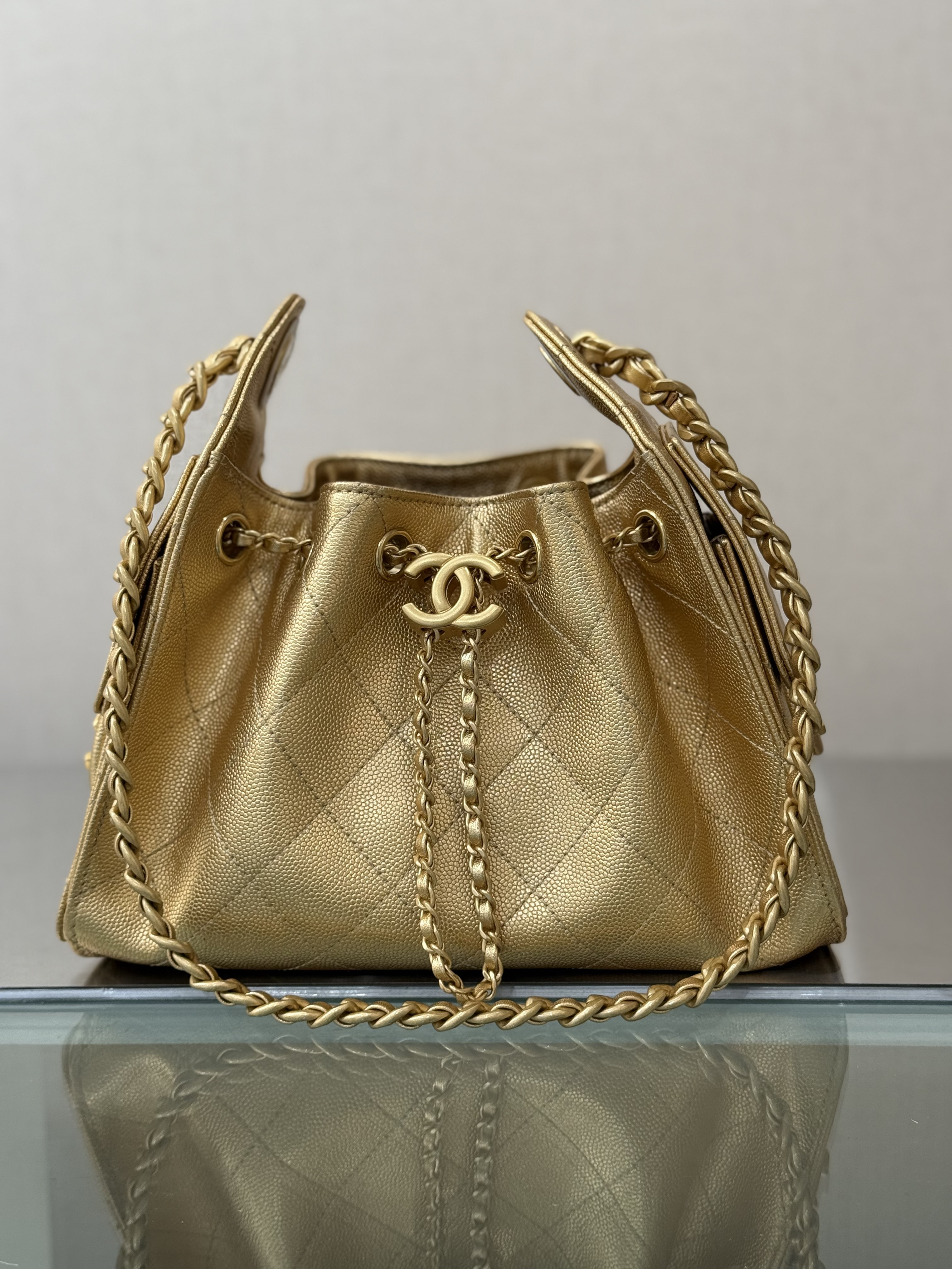 Spring-Summer 2025 Gold Metallic Quilted Grained Calfskin Drawstring Bucket Bag with Gold-Tone Hardware
