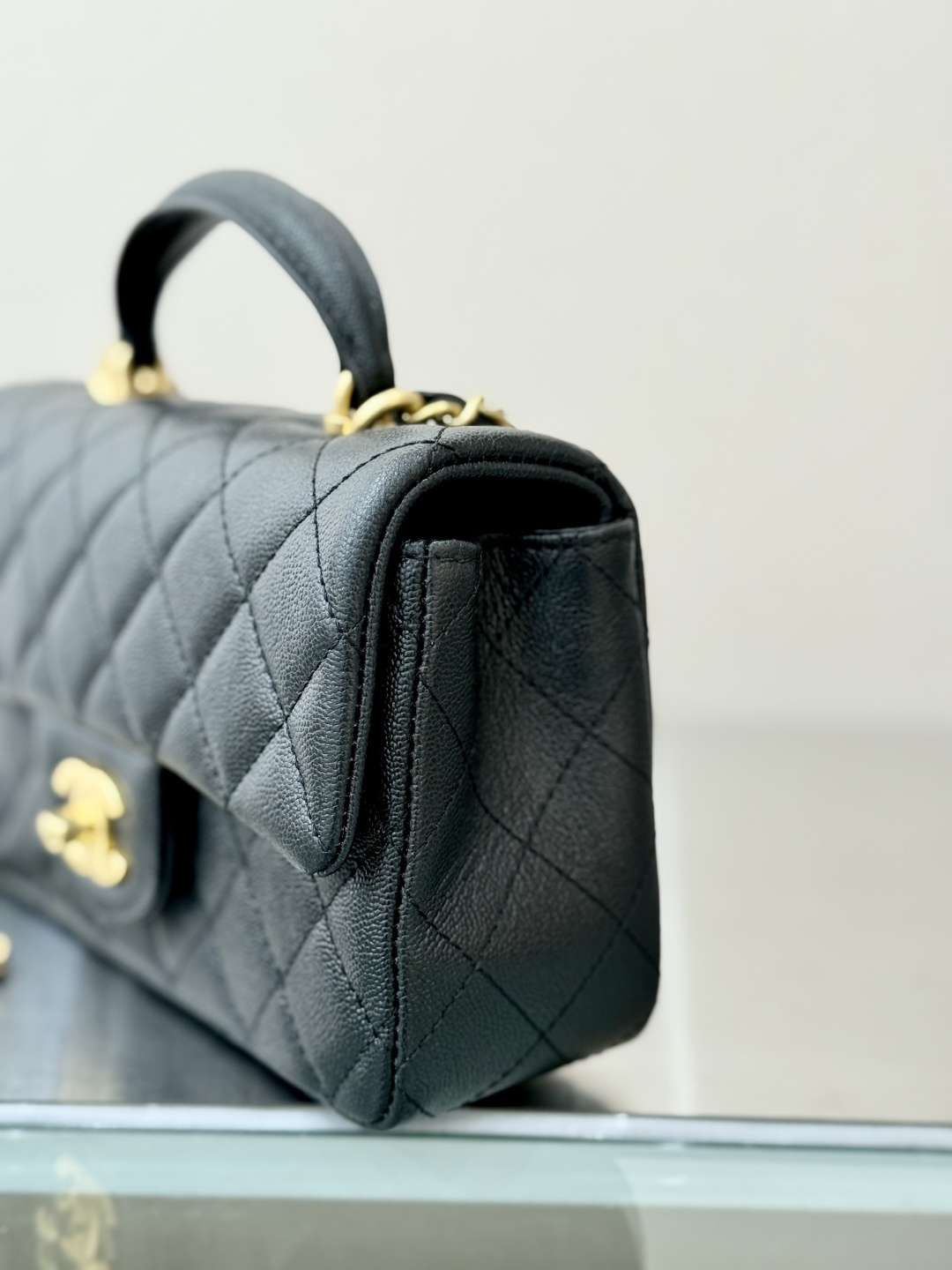 Mini Flap Bag with Top Handle (AS2215) in Black Quilted Grained Calfskin (Caviar) with Antique Gold-Tone Hardware
