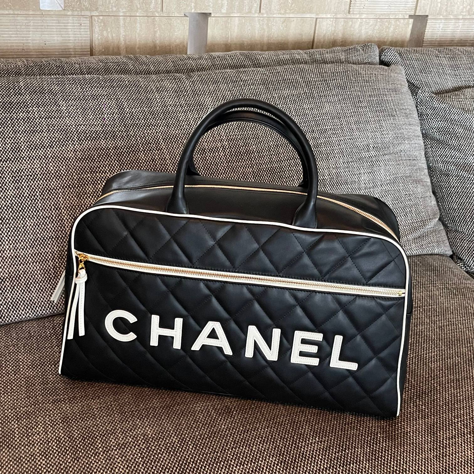 Vintage Black Quilted Calfskin Boston Handbag with White Trim and Chanel Logo Appliqué