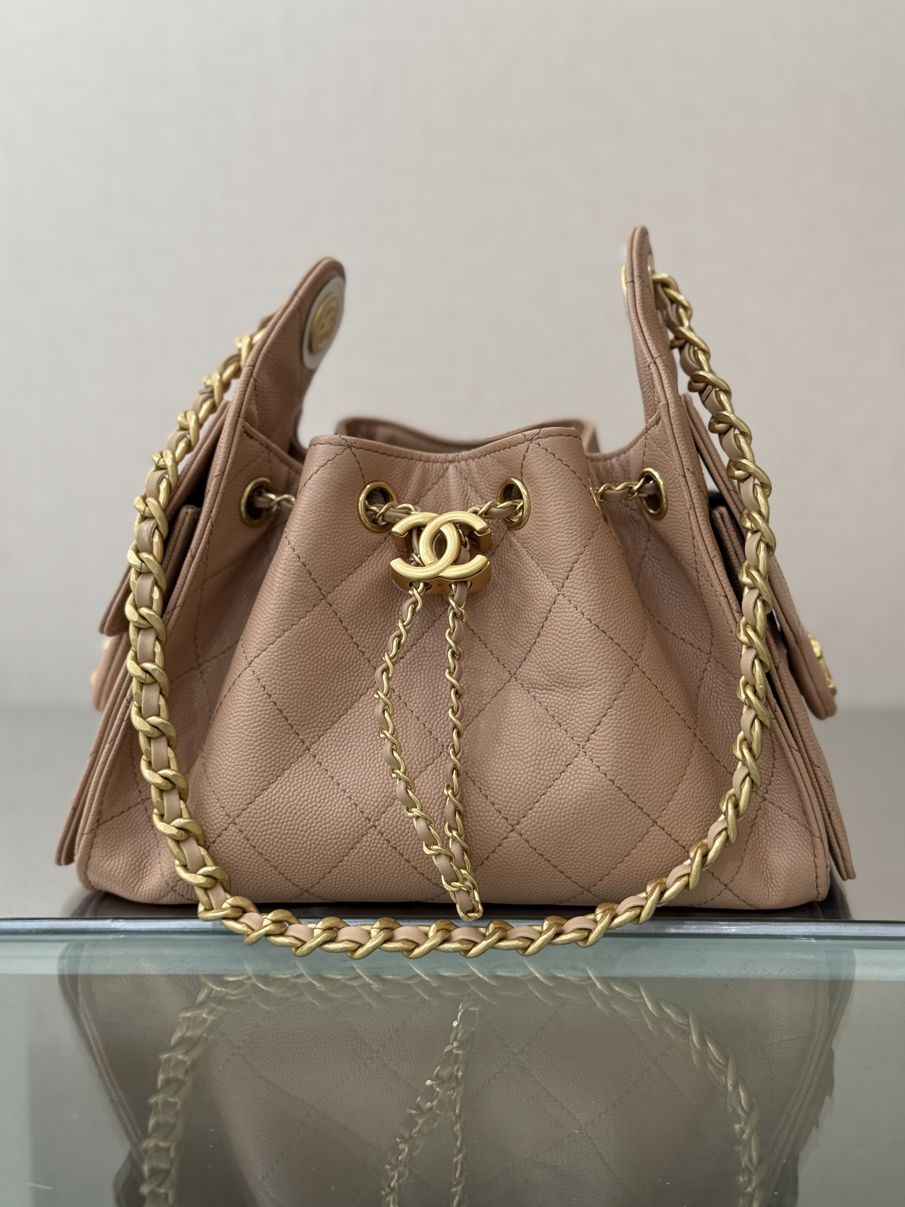 Spring-Summer 2025 Beige Quilted Grained Calfskin Drawstring Bucket Bag with Gold-Tone Hardware