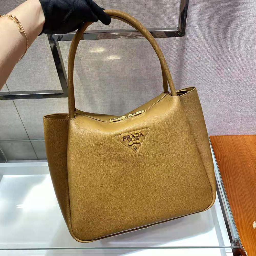 Prada Women Medium Leather Handbag with the Prada Metal Lettering Logo Illuminating Its Center-Brown